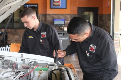 2 men  working on engine