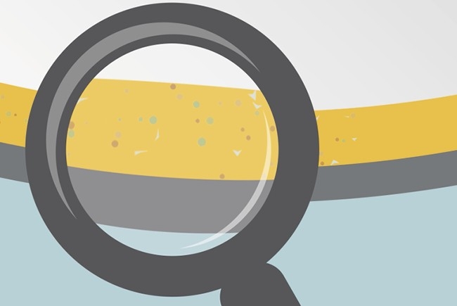 clean lubricants Looking at oil through magnifying glass