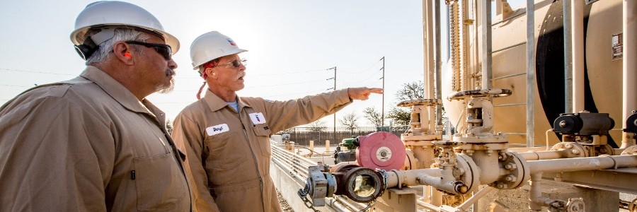 Men observing machinery