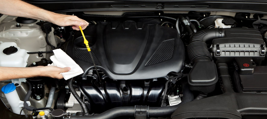 Mechanic checking oil