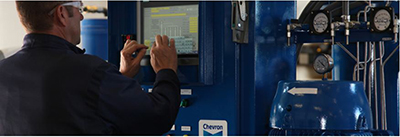 Comparing a typical hydraulic oil to certified clean hydraulic oil Man doing diagnosis