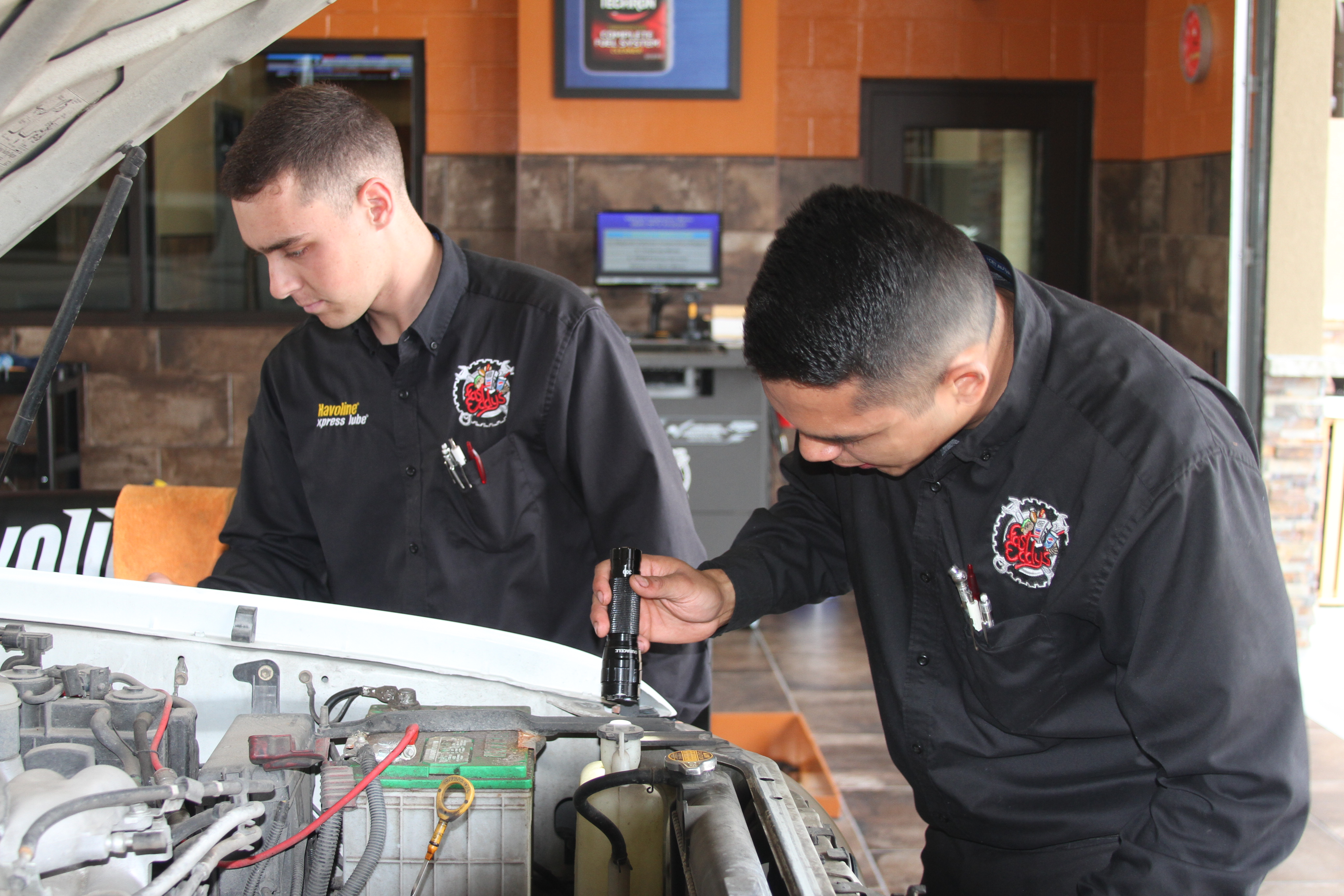 2 men  working on engine