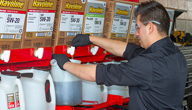 Man pouring oil from PitPack rack