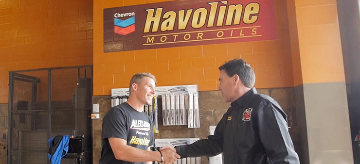 Alex touring Eddy's xpress lube Alex Laughlin shaking hands with Steve Eddy